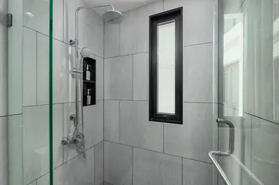 a bathroom with a shower and a window in it at Safi 1BR Suite — The Title Legendary BangTao in Bang Tao Beach