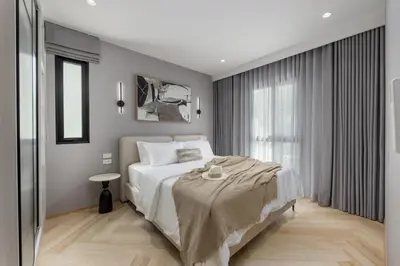 a bedroom with a large white bed and a window at Safi 1BR Suite — The Title Legendary BangTao in Bang Tao Beach