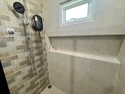 a bathroom with a shower with a shower head at Modern townhome in Phuket in Ban Phak Chit