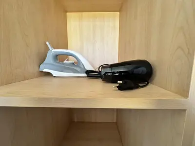 a shelf with a telephone and a mask on it at Modern townhome in Phuket in Ban Phak Chit