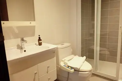 a bathroom with a toilet and a sink and a shower at Private Jacuzzi Pool Suite near walking street in Patong Beach