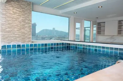 a swimming pool with a view of a building at Private Jacuzzi Pool Suite near walking street in Patong Beach