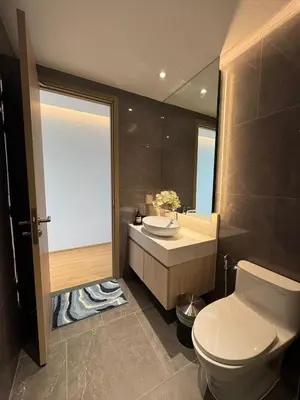a bathroom with a toilet and a sink and a mirror at Modern 1BR Condo Top Floor Pool, Cinema & Fast WiFi Next to Boat Avenue in Phuket