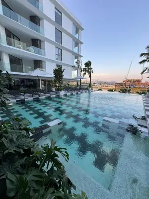 a large swimming pool in front of a building at Modern 1BR Condo Top Floor Pool, Cinema & Fast WiFi Next to Boat Avenue in Phuket