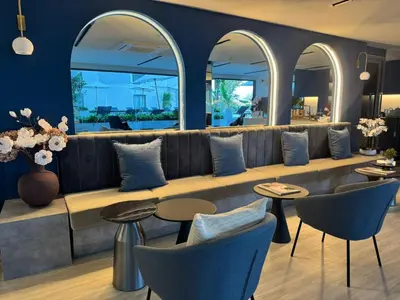 a lobby with a long couch and chairs and tables at Modern 1BR Condo Top Floor Pool, Cinema & Fast WiFi Next to Boat Avenue in Phuket