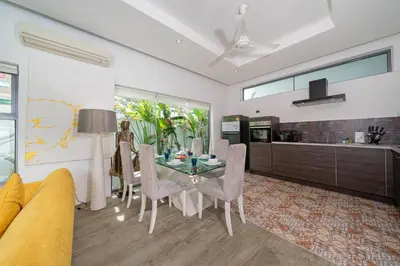a kitchen and dining room with a table and chairs at 2 BR Pool Villa Isawan near Nai Harn in Ban Saiyuan (1)