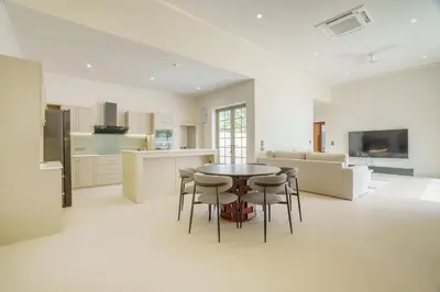 a kitchen and living room with a table and chairs at New Celine Villa Private Pool Near Beaches in Ban Saiyuan (1)