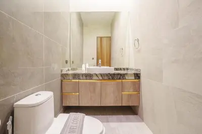 a bathroom with a white toilet and a sink at New Celine Villa Private Pool Near Beaches in Ban Saiyuan (1)