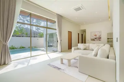 a living room with a white couch and a table at New Celine Villa Private Pool Near Beaches in Ban Saiyuan (1)