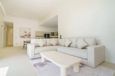 a living room with a white couch and a table at New Celine Villa Private Pool Near Beaches in Ban Saiyuan (1)