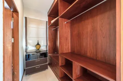 a walk in closet with wood paneling and a cabinet at 3 BR Pool Villa Salika near Rawai Beach in Ban Saiyuan (1)