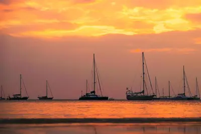 a group of sailboats in the water at sunset at 3 BR Pool Villa Salika near Rawai Beach in Ban Saiyuan (1)
