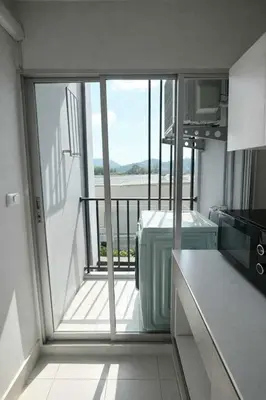 a kitchen with a view of a balcony at D Condo Mine Kathu Smart Monthly Living 30-Day Stay in Kathu