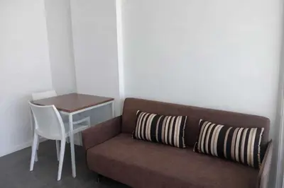 a couch in a room with a table and a desk at D Condo Mine Kathu Smart Monthly Living 30-Day Stay in Kathu