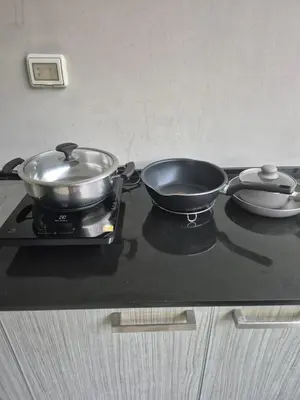 a pot and a pan sitting on a stove at The Ark Condomisunset in Ban Karon