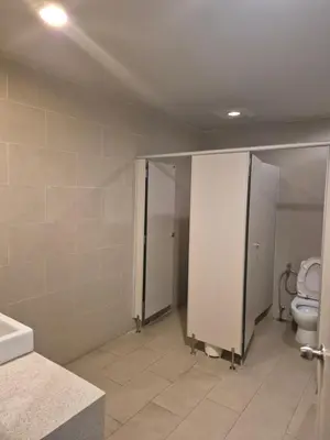 a bathroom with a toilet and stalls in it at The Ark Condomisunset in Ban Karon