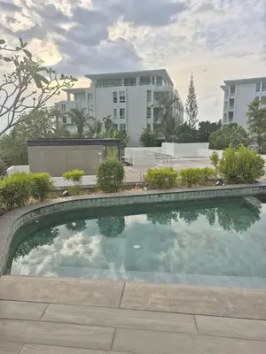 a swimming pool in front of some buildings at The Ark Condomisunset in Ban Karon