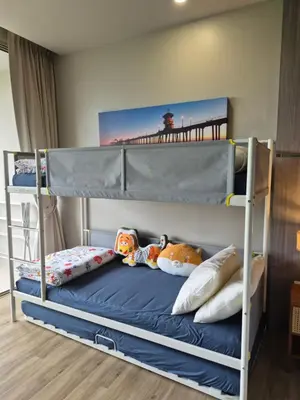 a bunk bed with toys on it in a bedroom at The Ark Condomisunset in Ban Karon