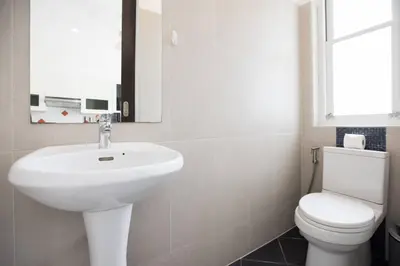 a bathroom with a white sink and a toilet at Green 9 Private Pool Villa 2BR near Rawai Beach in Ban Saiyuan (1)