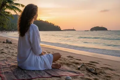 a woman sitting on the beach watching the sunset at Green 9 Private Pool Villa 2BR near Rawai Beach in Ban Saiyuan (1)