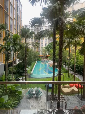 a view from the balcony of a hotel with a swimming pool at Rest&Rise Phuket in Ban Rangeng