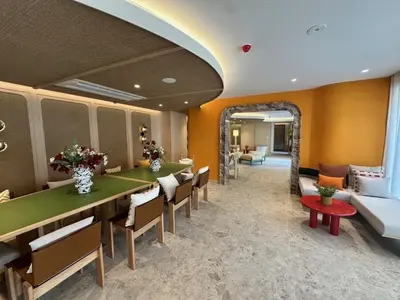 a restaurant with a long table and chairs and a couch at Rest&Rise Phuket in Ban Rangeng