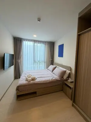 a bedroom with a large bed and a television at Rest&Rise Phuket in Ban Rangeng