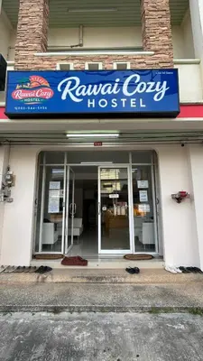 a building with a sign for a retrieval cow hospital at rawai cozy hostel in Rawai Beach
