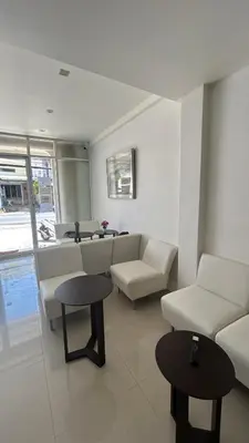 a living room with a couch and a table at rawai cozy hostel in Rawai Beach