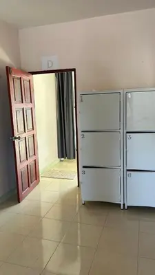 a room with two refrigerators and an open door at rawai cozy hostel in Rawai Beach