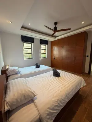 a large bedroom with two beds and a ceiling fan at Harmony 3 Bedrooms Private Pool Villa in Laguna Phuket