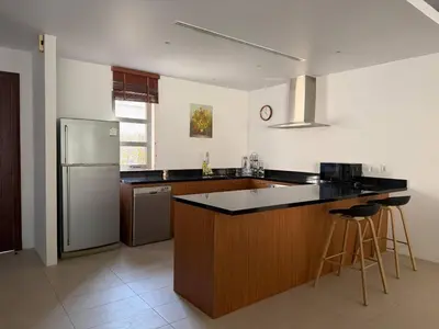 a kitchen with a refrigerator and a counter top at Harmony 3 Bedrooms Private Pool Villa in Laguna Phuket