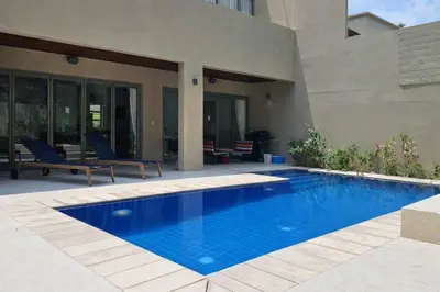 a swimming pool in front of a house at Harmony 3 Bedrooms Private Pool Villa in Laguna Phuket