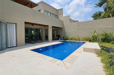 a swimming pool in front of a house at Harmony 3 Bedrooms Private Pool Villa in Laguna Phuket