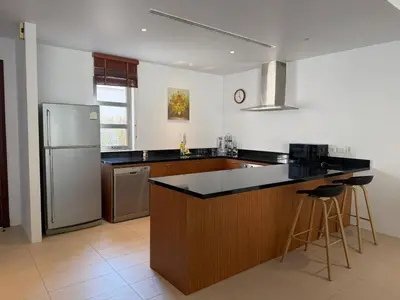 a kitchen with a refrigerator and a counter top at Harmony 3 Bedrooms Private Pool Villa in Laguna Phuket