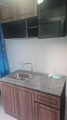 a kitchen counter with a sink and a mirror at Dcondo in Ban Kathu