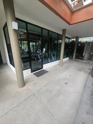 an empty building with glass windows and columns at Dcondo in Ban Kathu