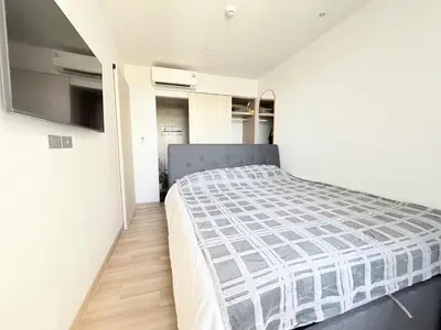 a bedroom with a bed in a white room at Skypark 4th floor Mountain View terrace in Laguna Phuket