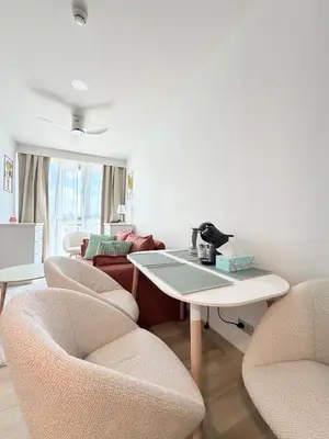 a living room with chairs and a table and a couch at Skypark 4th floor Mountain View terrace in Laguna Phuket