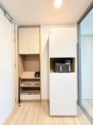 a kitchen with white cabinets and a refrigerator at Skypark 4th floor Mountain View terrace in Laguna Phuket