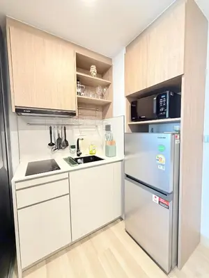 a white kitchen with a refrigerator and a microwave at Skypark 4th floor Mountain View terrace in Laguna Phuket