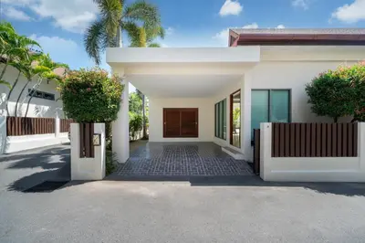 a white house with a gate and a driveway at 2BR Pool Villa Kate - KA Villas near Rawai Beach in Rawai Beach