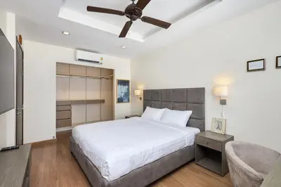 a bedroom with a bed and a ceiling fan at Townhouse Laguna Park 3 bedrooms in Laguna Phuket