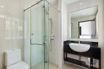 a bathroom with a glass shower and a sink at Townhouse Laguna Park 3 bedrooms in Laguna Phuket