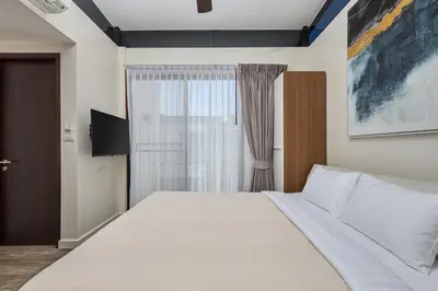 a bedroom with a large white bed and a window at Townhouse Laguna Park 3 bedrooms in Laguna Phuket