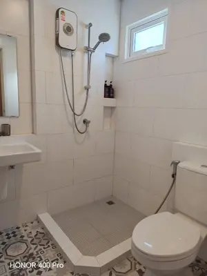 a bathroom with a shower with a toilet and a sink at Phuket Paklok Cozy Home in Ban Pa Khlok