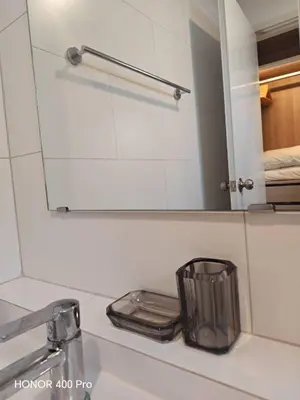 a bathroom sink with a mirror over a sink at Phuket Paklok Cozy Home in Ban Pa Khlok