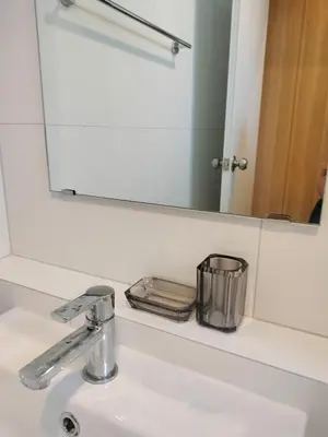 a bathroom sink with a mirror and a sink at Phuket Paklok Cozy Home in Ban Pa Khlok