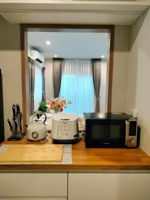 a kitchen counter with a microwave and a toaster oven at Phuket Paklok Cozy Home in Ban Pa Khlok