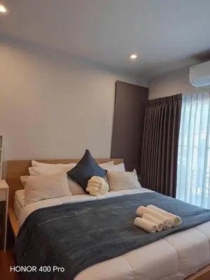 a large bed with two pillows on top of it at Phuket Paklok Cozy Home in Ban Pa Khlok